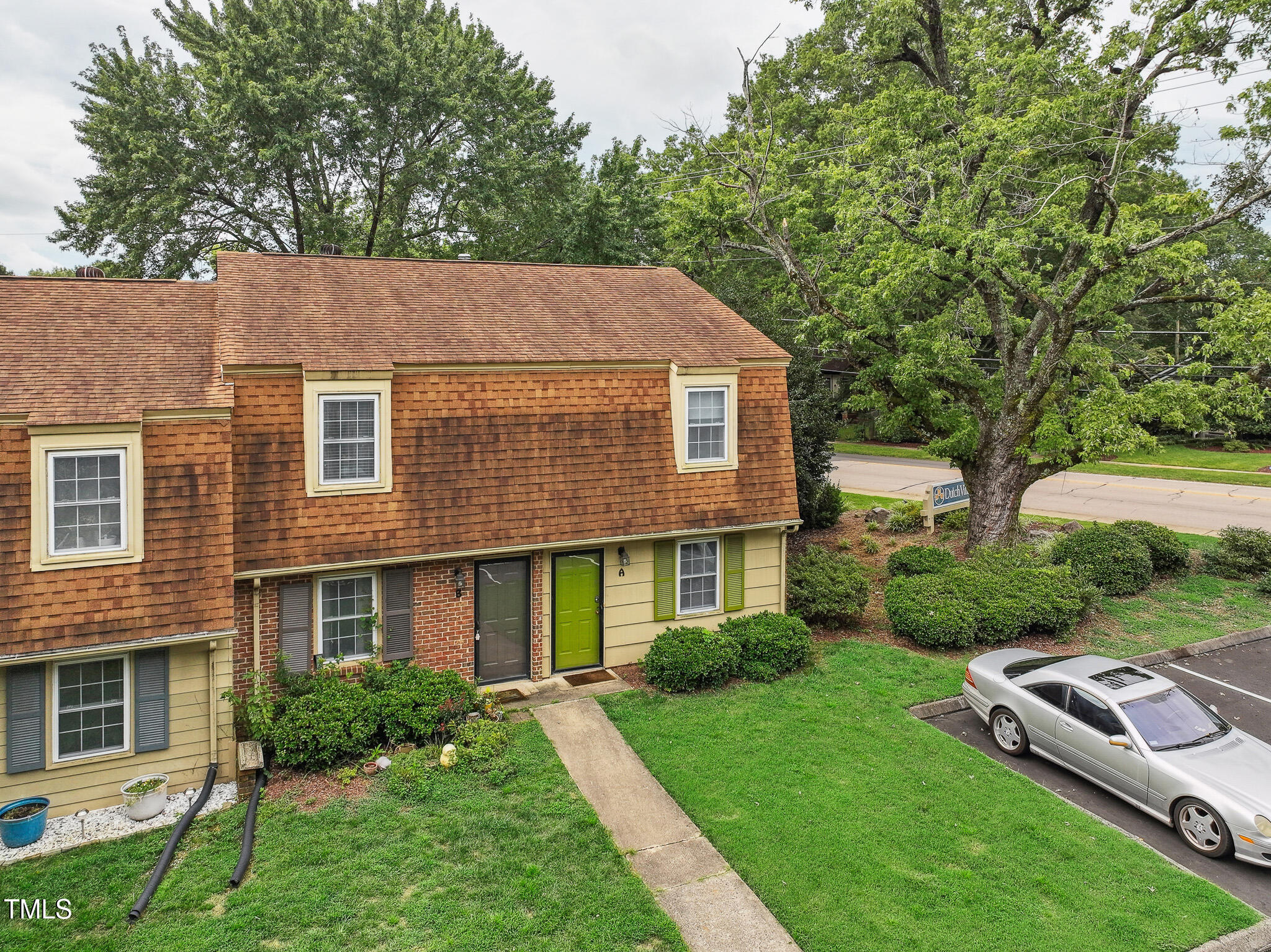 149 Jones Franklin Road, Unit A Raleigh, NC 27606 - Photo 2 of 21 a aerial view of a house next to a big yard and large trees