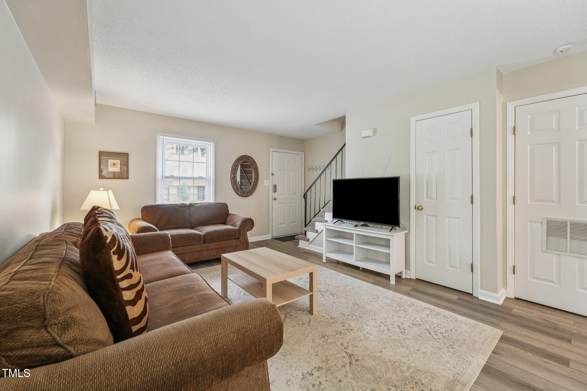 149 Jones Franklin Road, Unit A Raleigh, NC 27606 - Photo 4 of 21 a living room with furniture and a flat screen tv