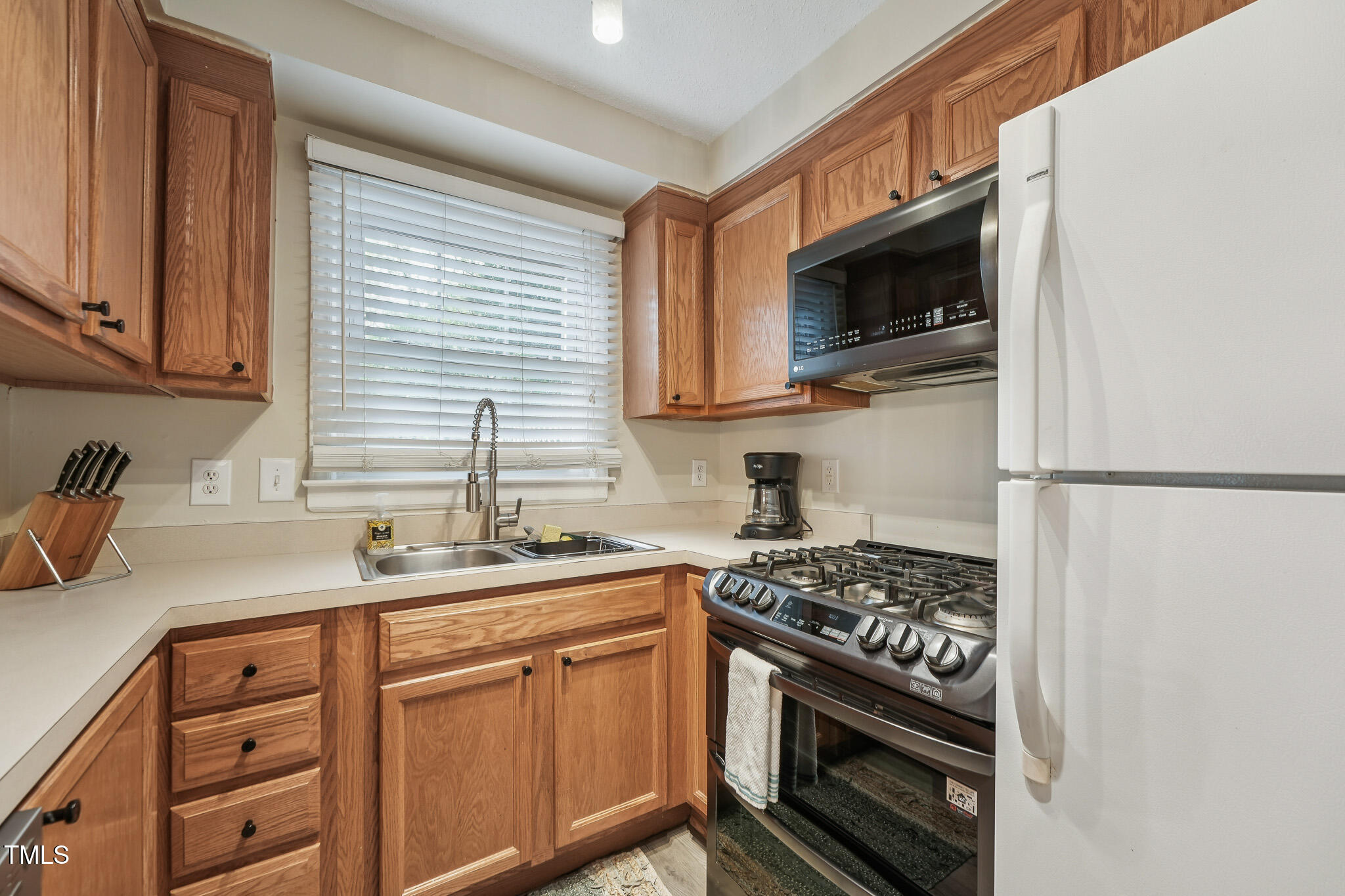 149 Jones Franklin Road, Unit A Raleigh, NC 27606 - Photo 5 of 21 a kitchen with stainless steel appliances a sink stove and microwave