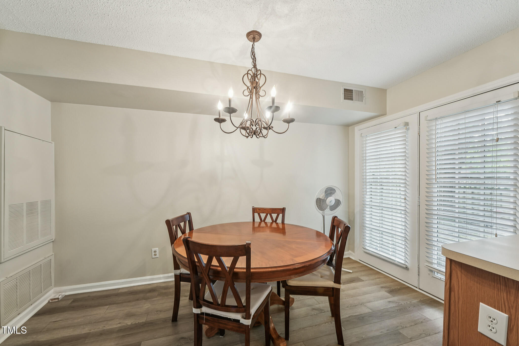 149 Jones Franklin Road, Unit A Raleigh, NC 27606 - Photo 6 of 21 a view of a dining room with furniture and chandelier