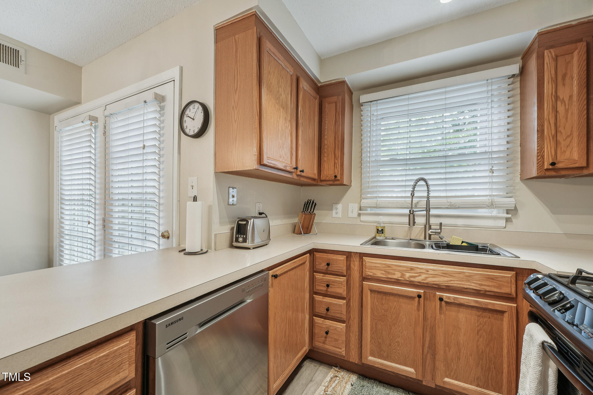 149 Jones Franklin Road, Unit A Raleigh, NC 27606 - Photo 7 of 21 a kitchen with stainless steel appliances granite countertop a sink a stove and cabinets