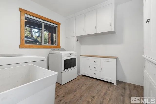 a utility room with cabinets washer and dryer