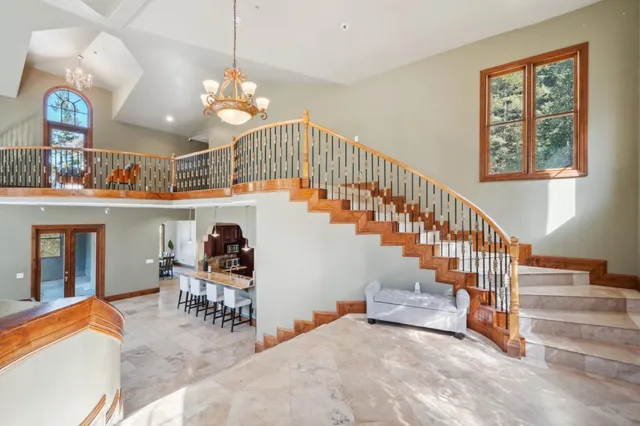 a view of a dining room with furniture and a chandelier