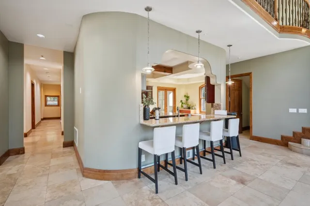 a view of a dining room with furniture and a chandelier