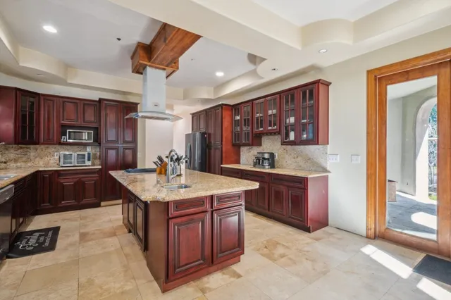 a kitchen with stainless steel appliances granite countertop a sink dishwasher stove and oven
