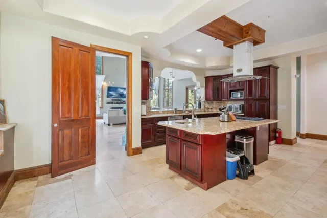 a kitchen with stainless steel appliances granite countertop a stove and a sink