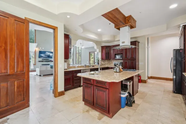 a kitchen with a stove a refrigerator and a sink