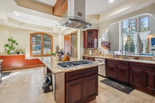 a kitchen with stainless steel appliances granite countertop a sink stove and cabinets