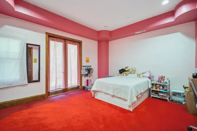 a spacious bedroom with a bed and a window