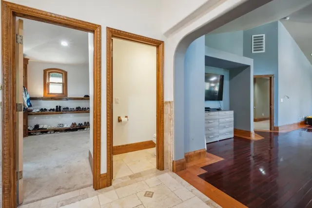 a view of a hallway with wooden floor a living room and dining room