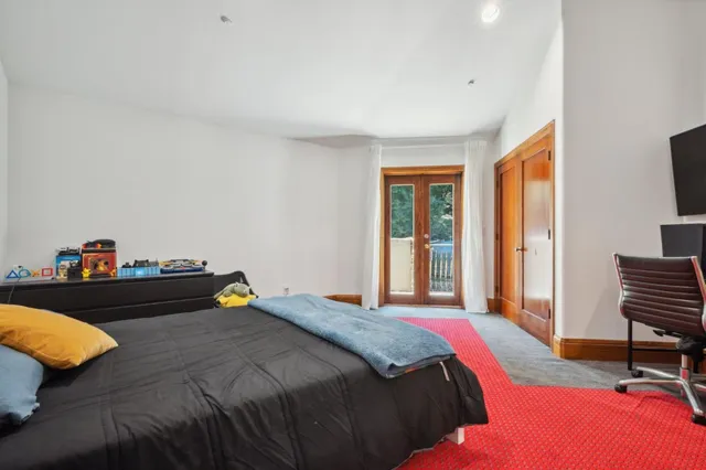 a bed sitting in a bedroom next to a window