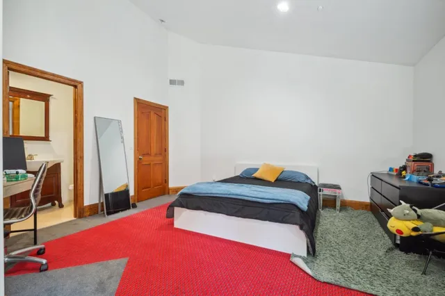 a bedroom with a bed and a table in it