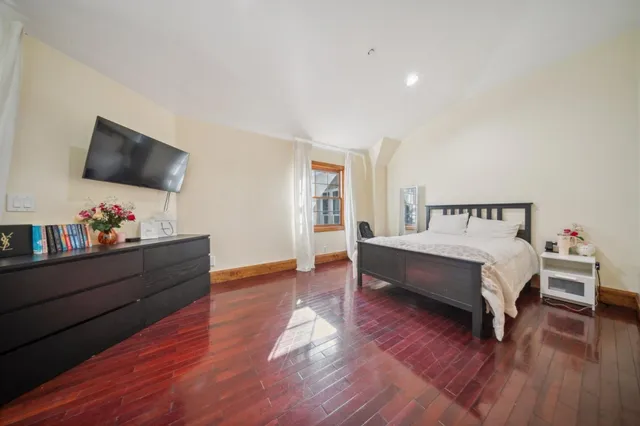 a bed room with furniture and a flat screen tv