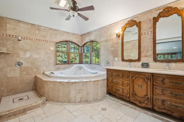 a bath room with a sink a vanity and a mirror