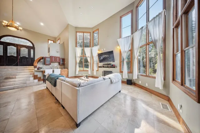 a living room with furniture and large windows