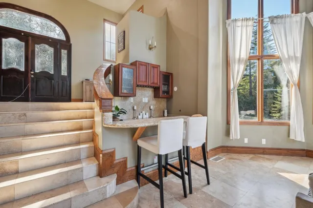 a dining room with furniture and a window
