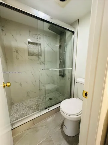 a bathroom with a shower and a toilet