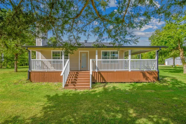 a backyard of a house with lots of green space