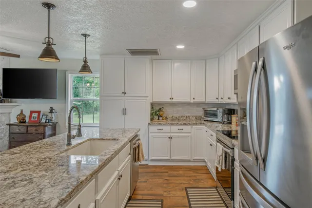a kitchen with a sink stove and refrigerator
