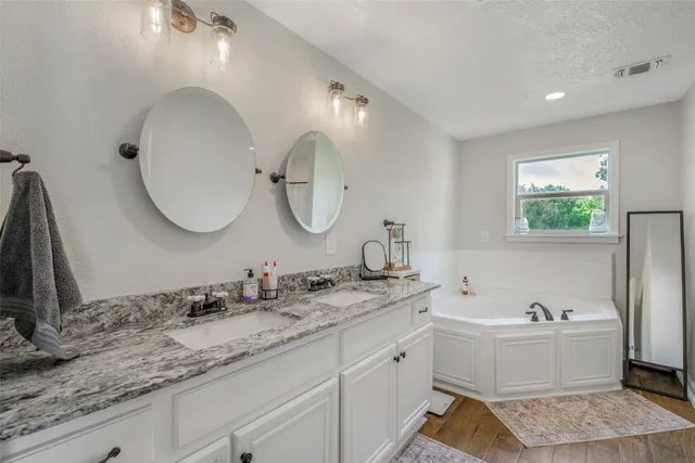 a bathroom with a double vanity sink and a mirror