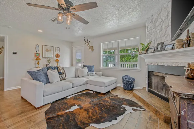 a living room with furniture and a fireplace