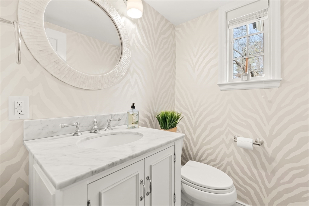 27 Radcliffe Road Wellesley, MA 02482 - Photo 16 of 38 a bathroom with a sink a toilet and a mirror