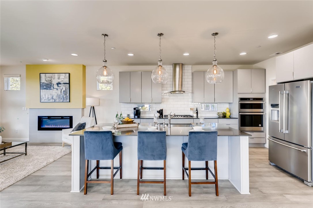 4427 232nd Place Southeast, Unit 20 Bothell, WA 98021 - Photo 12 of 28 a kitchen with cabinets a counter space stainless steel appliances and a dining table
