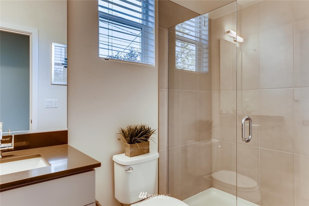 4427 232nd Place Southeast, Unit 20 Bothell, WA 98021 - Photo 13 of 28 a bathroom with a toilet sink and shower