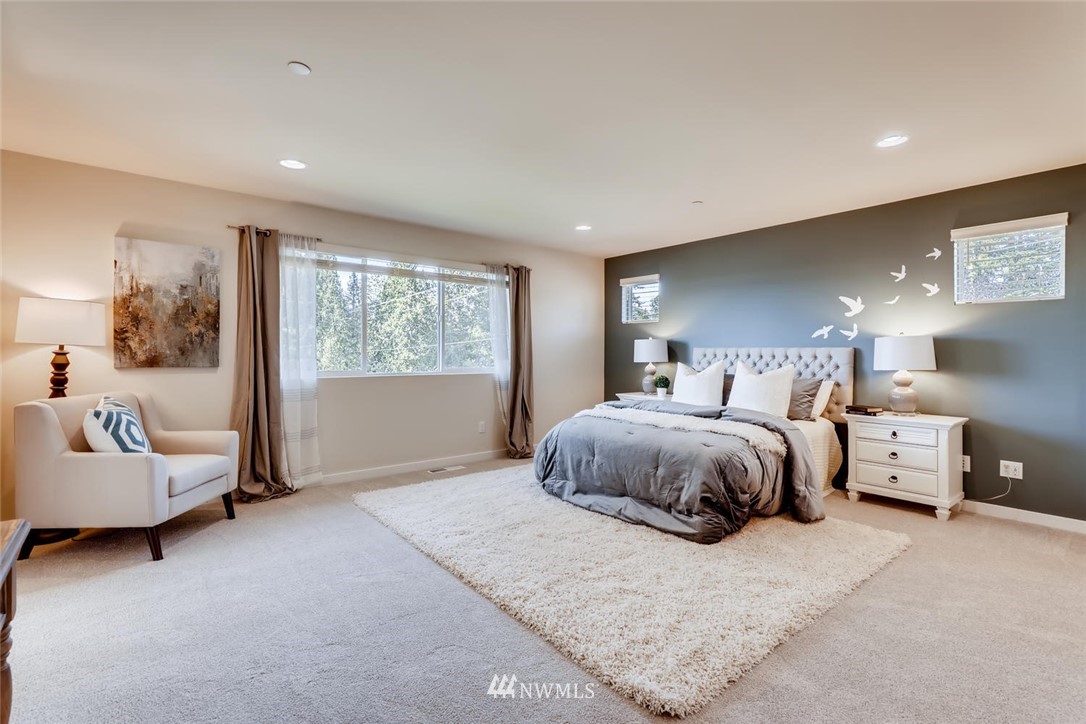 4427 232nd Place Southeast, Unit 20 Bothell, WA 98021 - Photo 14 of 28 a spacious bedroom with a bed and glass window