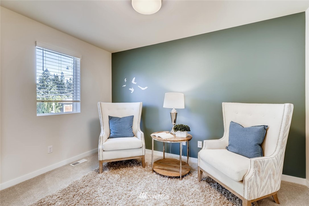 4427 232nd Place Southeast, Unit 20 Bothell, WA 98021 - Photo 16 of 28 a living room with furniture and a lamp