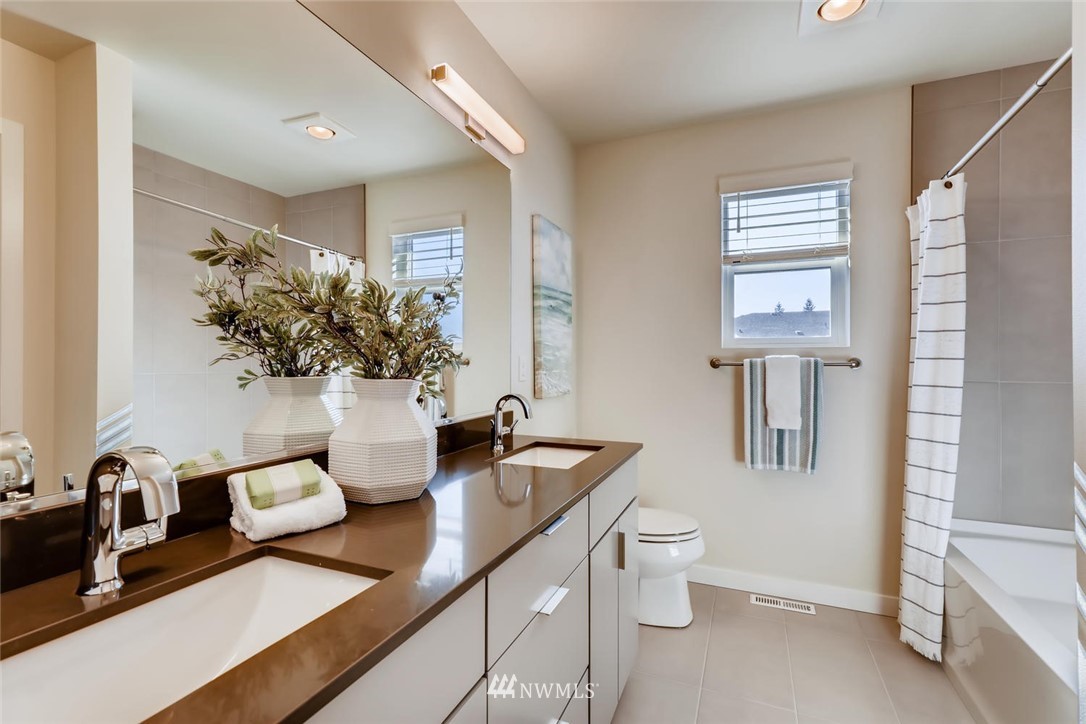4427 232nd Place Southeast, Unit 20 Bothell, WA 98021 - Photo 21 of 28 a view of bathroom with a potted plant on the counter and sink