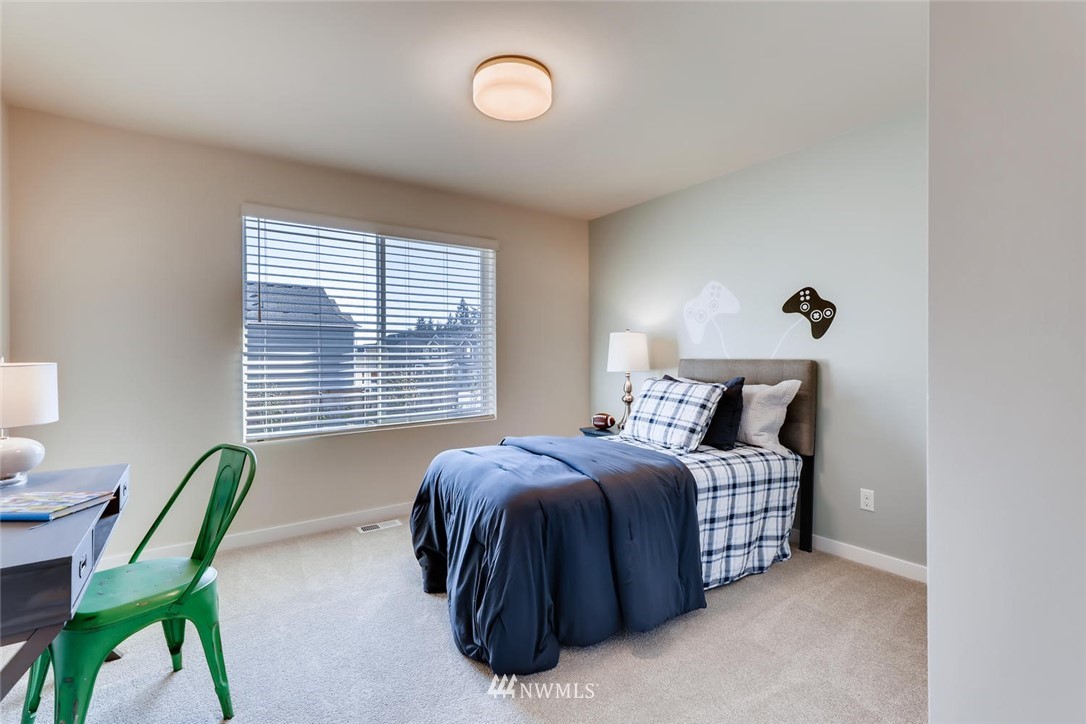 4427 232nd Place Southeast, Unit 20 Bothell, WA 98021 - Photo 22 of 28 a bed room with a bed window and a chair