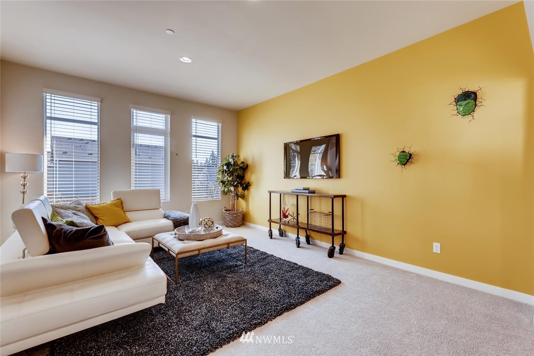 4427 232nd Place Southeast, Unit 20 Bothell, WA 98021 - Photo 23 of 28 a living room with furniture and a window