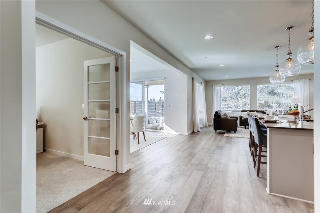 4427 232nd Place Southeast, Unit 20 Bothell, WA 98021 - Photo 6 of 28 a living room with furniture a large window and wooden floor