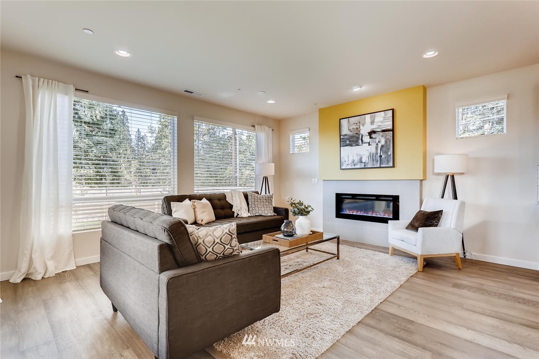 4427 232nd Place Southeast, Unit 20 Bothell, WA 98021 - Photo 7 of 28 a living room with furniture and a fireplace