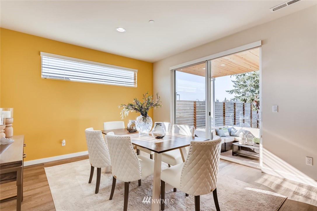 4427 232nd Place Southeast, Unit 20 Bothell, WA 98021 - Photo 9 of 28 a dining room with furniture and wooden floor