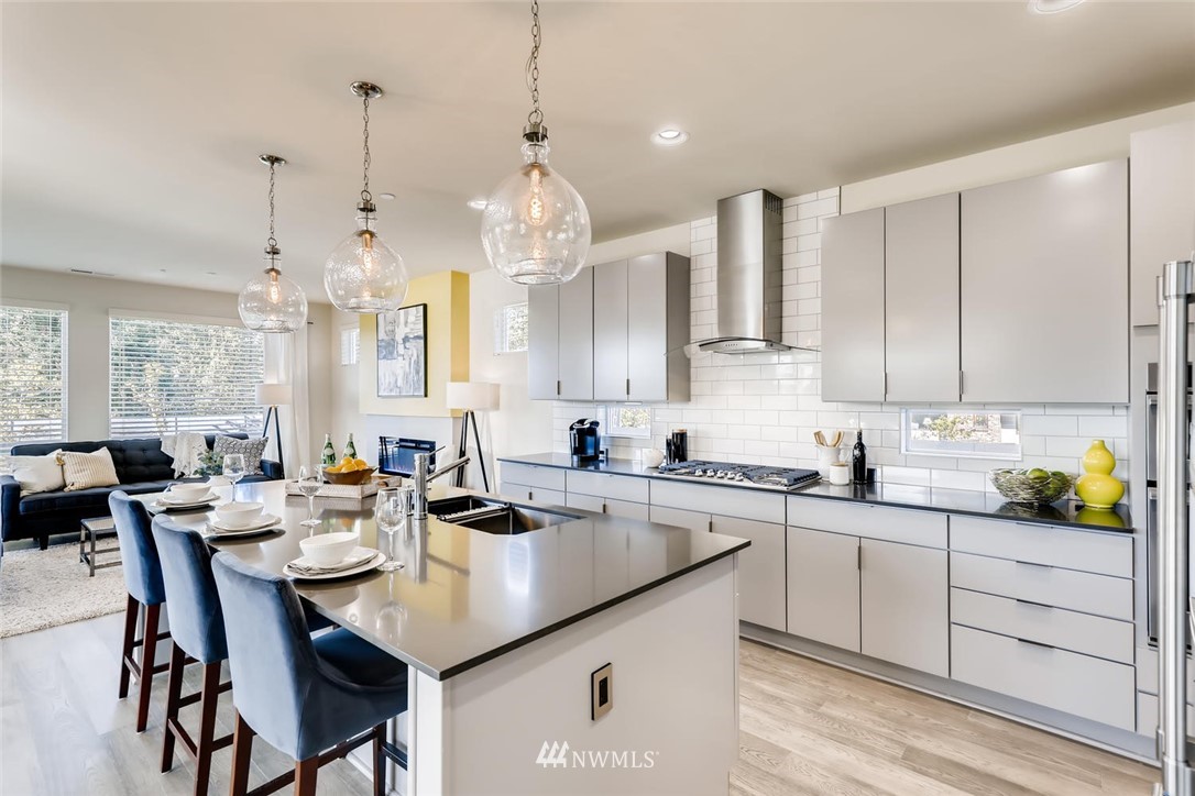 4427 232nd Place Southeast, Unit 20 Bothell, WA 98021 - Photo 10 of 28 a kitchen with sink cabinets and dining table chairs