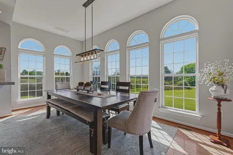 a view of a dining room with furniture window and wooden floor