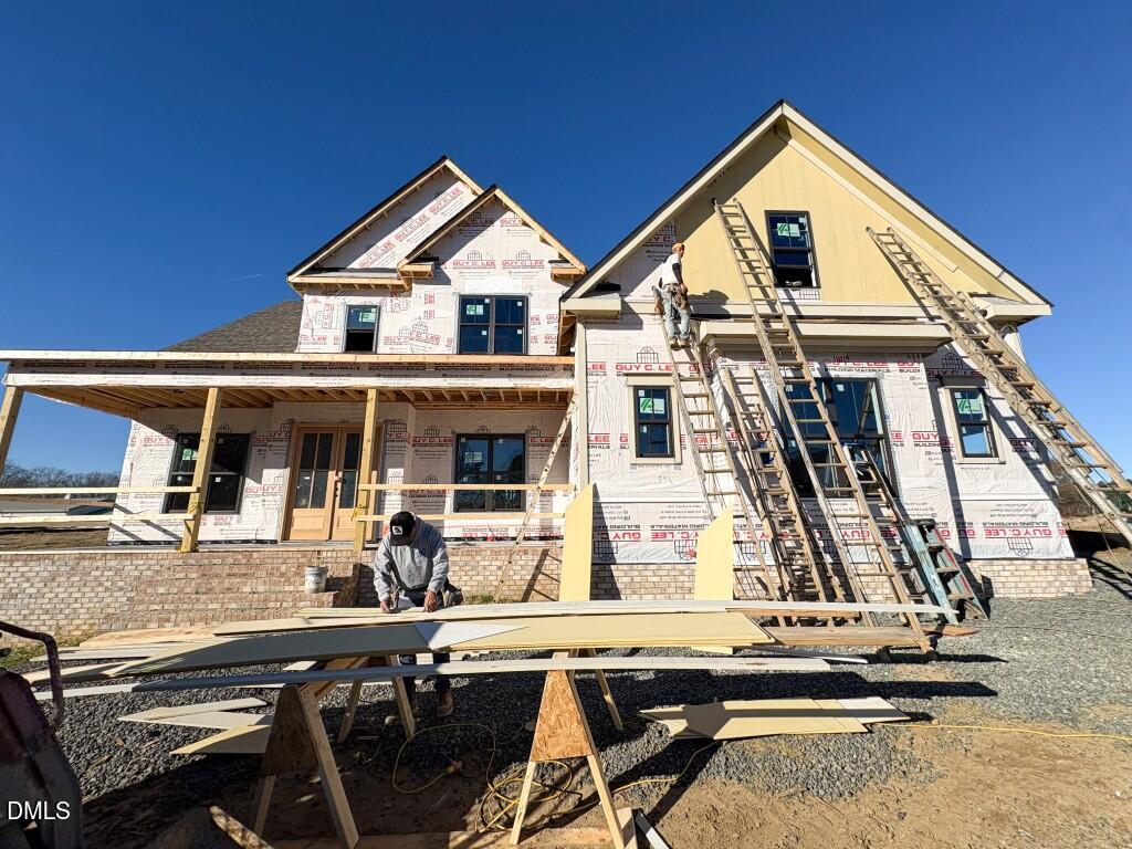 5848 Carriage Drive Raleigh, NC 27603 - Photo 1 of 24 a view of a white house with large windows and couches