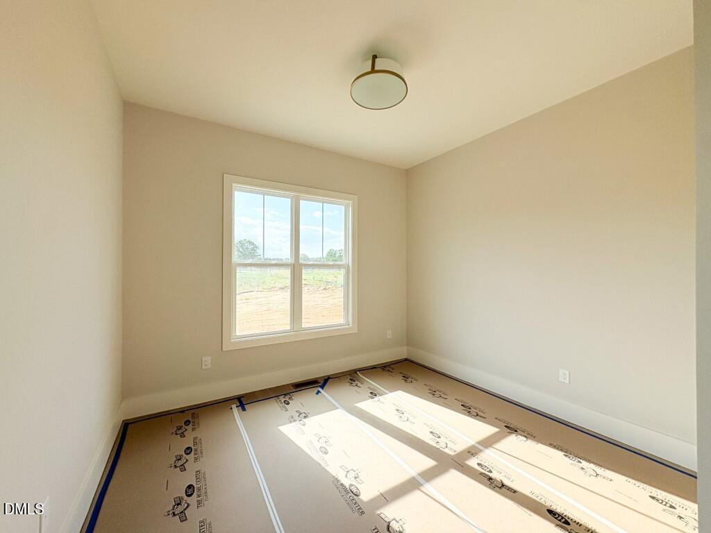 5848 Carriage Drive Raleigh, NC 27603 - Photo 9 of 28 a view of an empty room and window