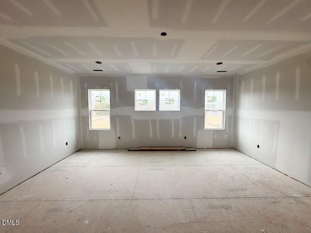 5848 Carriage Drive Raleigh, NC 27603 - Photo 11 of 26 an empty room with windows and closet