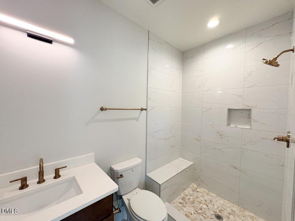 5848 Carriage Drive Raleigh, NC 27603 - Photo 12 of 28 a bathroom with a sink toilet and shower