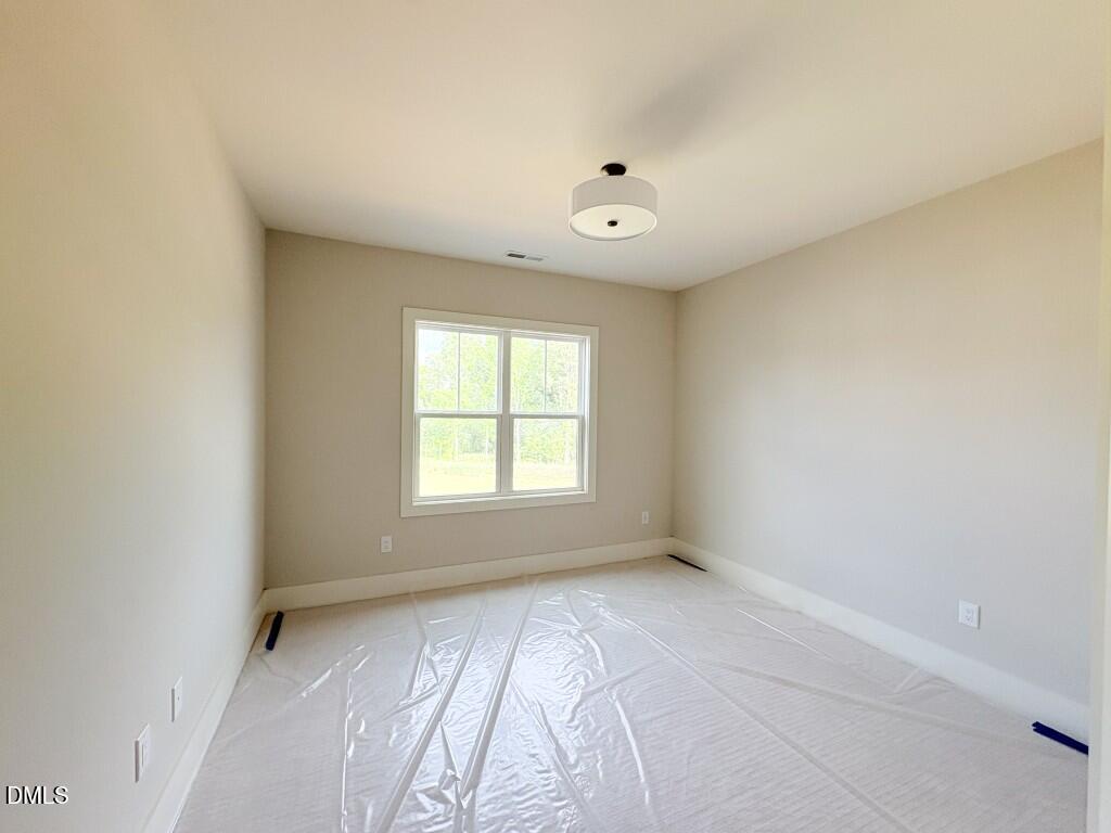 5848 Carriage Drive Raleigh, NC 27603 - Photo 13 of 28 an empty room with a window