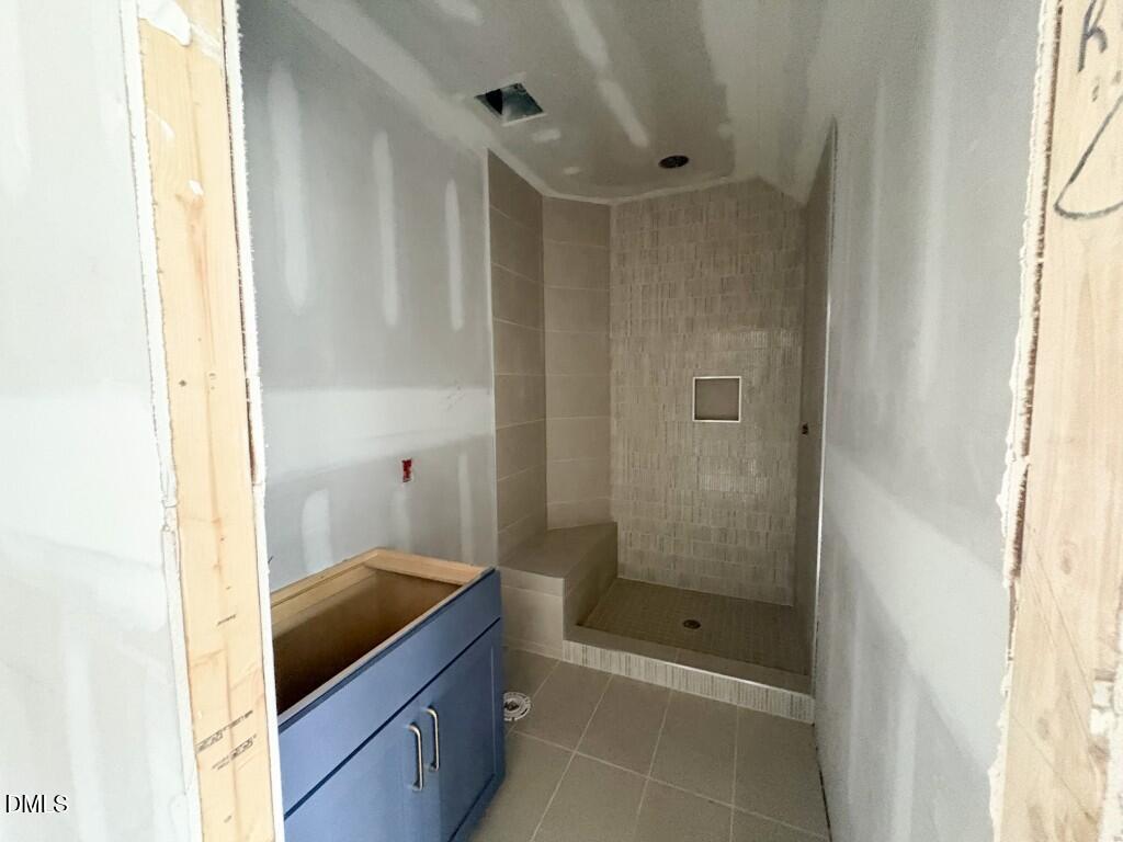 5848 Carriage Drive Raleigh, NC 27603 - Photo 13 of 26 a bathroom with a granite countertop sink a mirror and shower