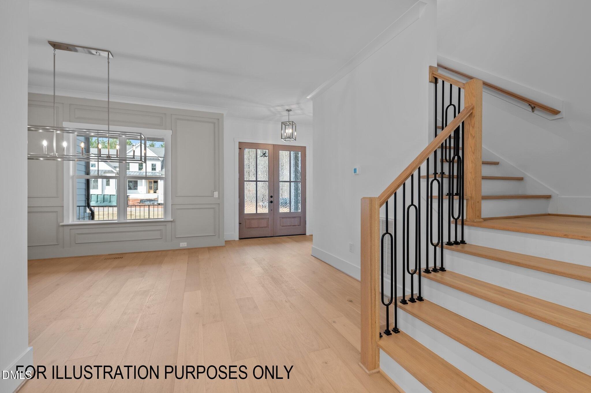 5848 Carriage Drive Raleigh, NC 27603 - Photo 17 of 26 a view of an empty room with wooden floor and fan