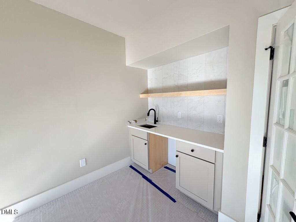 5848 Carriage Drive Raleigh, NC 27603 - Photo 18 of 28 a view of a hallway with white cabinets