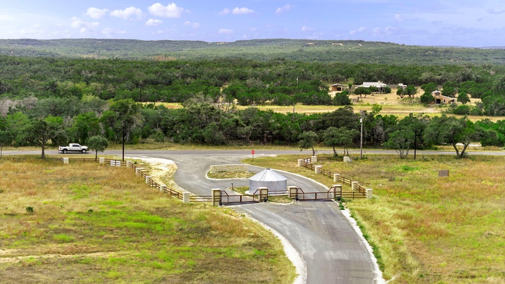 701 Windmill Ridge, Unit 90 Blanco, TX 78606 - Photo 15 of 18 a view of a swimming pool with a yard and large trees