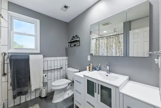 a bathroom with a sink toilet and shower