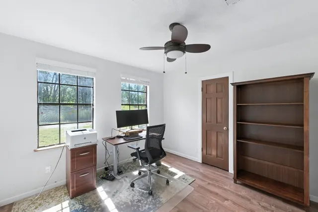 a view of a workspace with furniture and a window