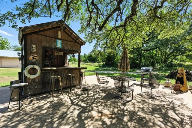 a view of a chair and table in backyard